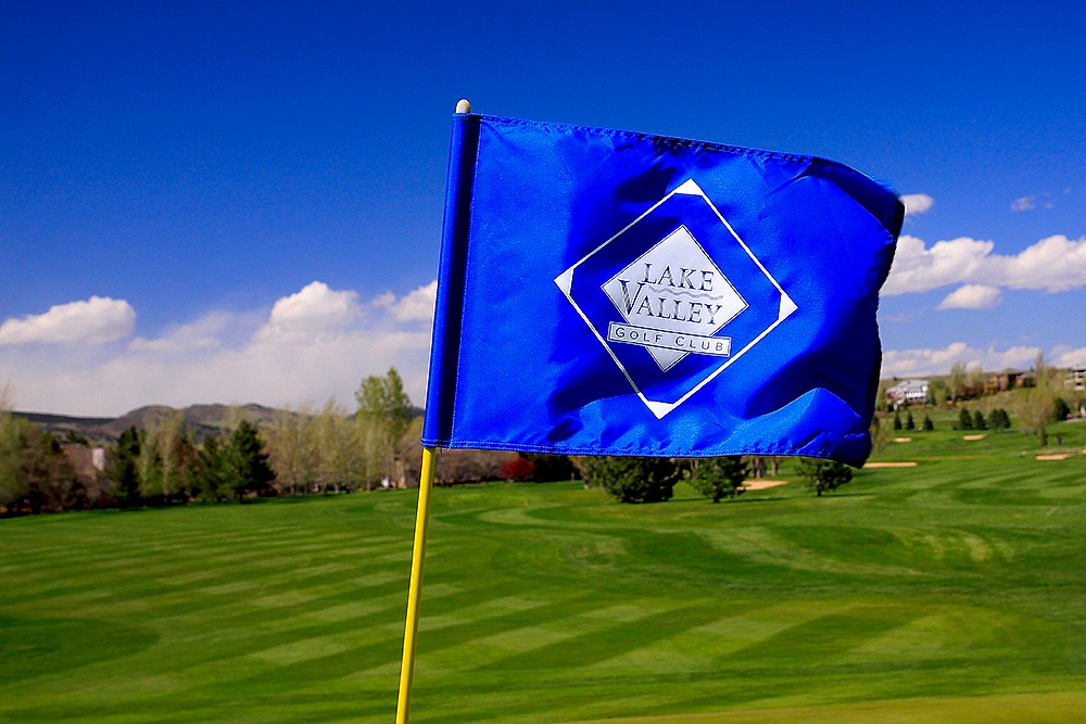 Blue Lake Valley Golf Club flag on pin with course and mountains in soft focus